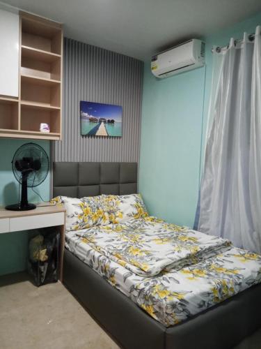 a bed in a room with a desk and a bed sidx sidx sidx at Welcome to Hambella home in Mactan