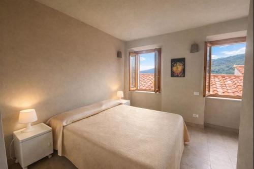 a bedroom with a bed and a window at Borgo Agapito in Marciana
