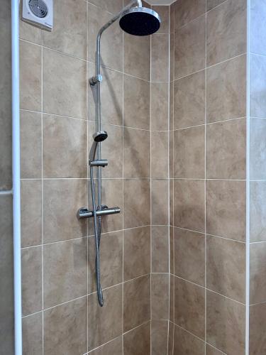 a shower with a shower head in a bathroom at Wilderness House Apartments by Smart Welcomes in Plymouth