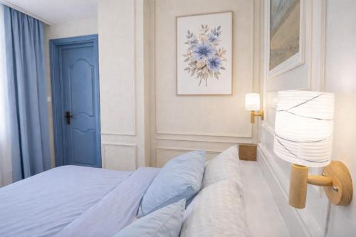 a bedroom with a bed and a blue door at City View Residence in Islamabad