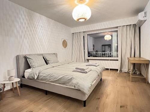 a bedroom with a bed and a large window at Casa Cielo-Spectacular View-Center-Chic-Spacious in Liège