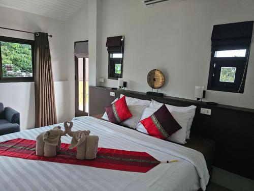a bedroom with a bed with two towels on it at DB Studios Samui - Adults Only in Lamai