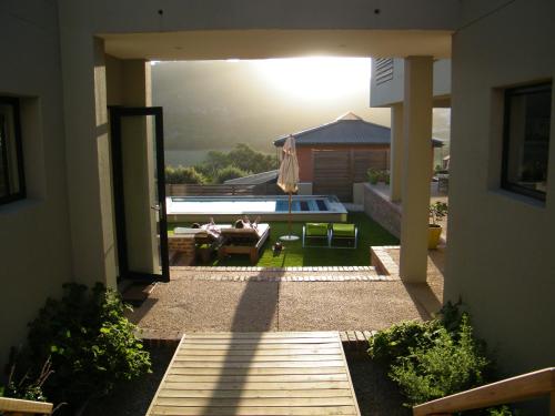 a view of a backyard with a pool and a house at Christiana Lodge in Plettenberg Bay