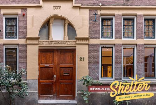 a building with two wooden doors and windows at Shelter City Christian Hostel in Amsterdam