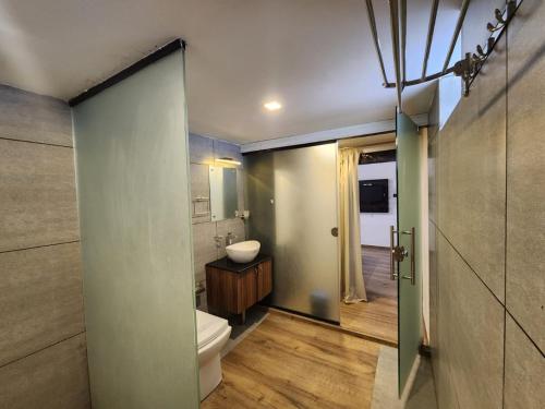 a bathroom with a toilet and a sink at 1 Forest Soul - Forest Side Retreat with Pool in Batheri
