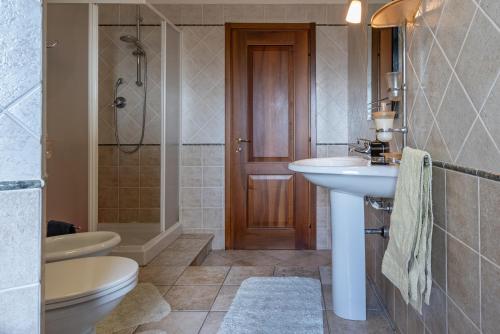 a bathroom with a sink and a toilet and a shower at ACQUARIO DEI FRALLE in Oristano
