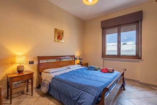 a bedroom with a bed and a window at ACQUARIO DEI FRALLE in Oristano