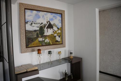 a painting of a church on a wall in a room at Hotel Holiday Foz in Foz do Iguaçu