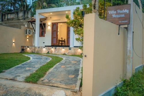 a house with a sign that reads villaoria therapy at Villa Paddy Heaven in Unawatuna