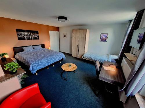 a hotel room with a bed and a couch at Le Tri Bèneu in Sivry