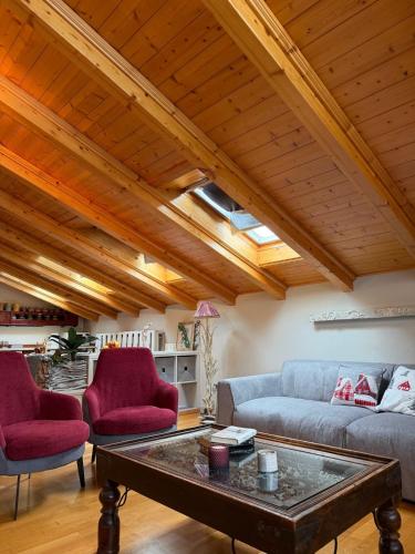a living room with a couch and a table at Bormio Urban Attic in Bormio