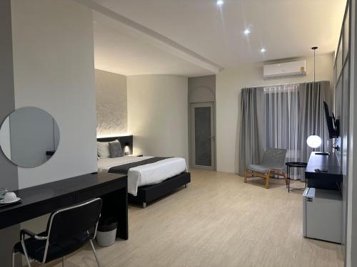 a hotel room with a bed and a desk at Lune bangkok in Bangna