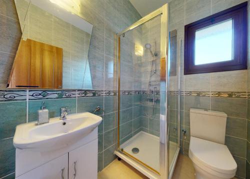 a bathroom with a toilet and a sink and a shower at Villa Magic Sunset in Kyrenia