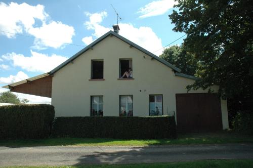 a white house with a dog in the window at Gite Du Grand Morin in Villeneuve-la-Lionne