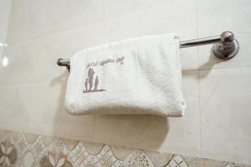 a towel hanging on a towel rack in a bathroom at Thai Residency - Opp to Bus Stand in Dhārāpuram