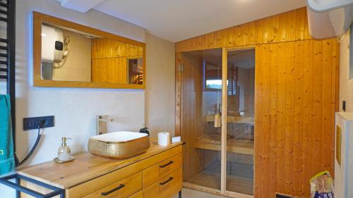 a bathroom with a shower and a wooden cabinet at Boroviti Mountain House in Blidinje