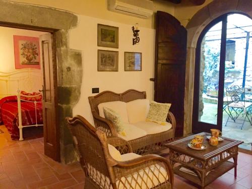 a living room with a chair and a table at Il Nido Cortona in Cortona