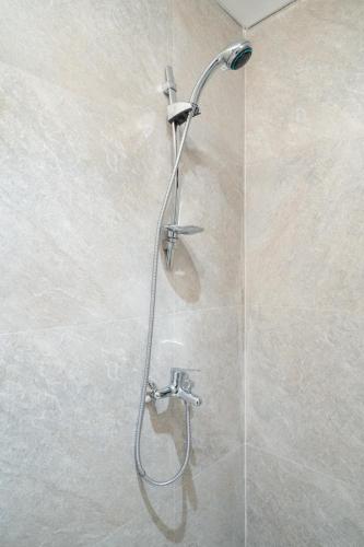 a shower with a shower head in a bathroom at ARA Stay By ARBA in Bandung