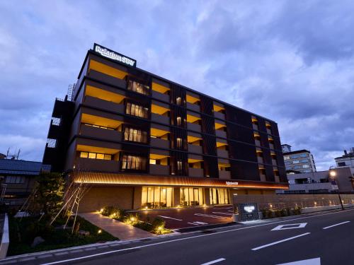 a black building with a sign on top of it at Rakuten STAY Awara Onsen in Awara