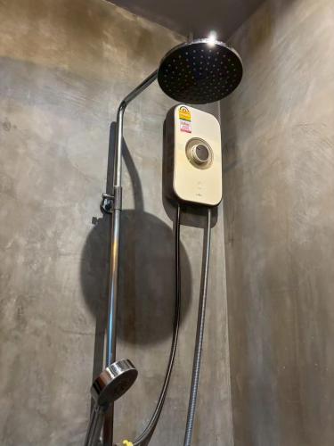 a shower with a shower head in a bathroom at Bangkok Phattanakan32 guest house in Bangkok