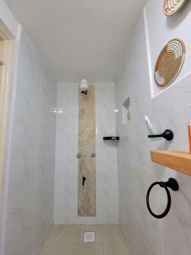 a shower with a glass door in a bathroom at Olkeleo HummingBird Cottage in Naivasha