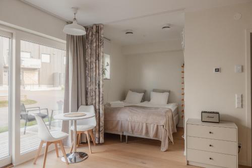 a bedroom with a bed and a table and chairs at The Oak - Ekerum Öland in Borgholm