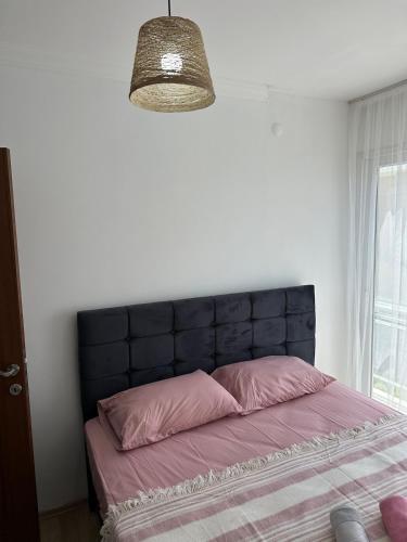 a bed with a black headboard in a bedroom at Eos in Çeşme