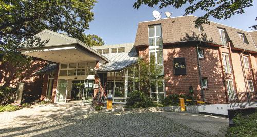 a building on a street with a building at PLAZA INN Schmöker-Hof in Norderstedt
