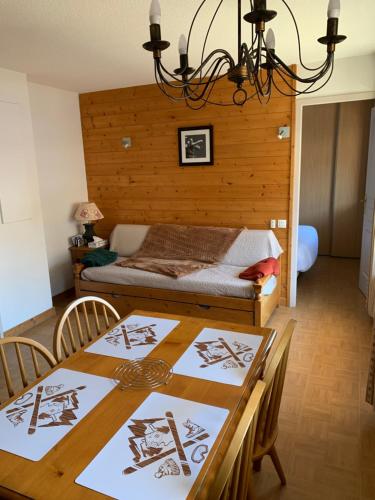a dining room with a table and a bed at Chalet des Evettes in Flumet