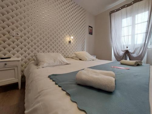 a bedroom with two beds with towels on them at Couvent de Vaylats in Vaylats