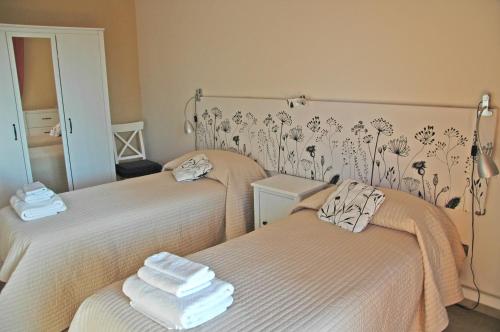 a room with two beds with towels on them at Le Anfore in Marino
