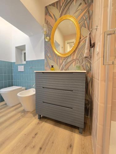 a bathroom with a sink and a mirror at Lovely Corner 2 in Porto Santo Stefano