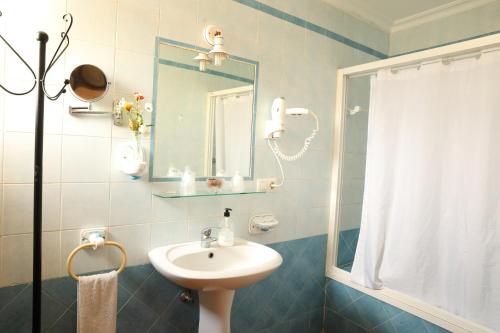 ein Badezimmer mit Waschbecken und Spiegel in der Unterkunft Hostal Rocio in Sanlúcar la Mayor