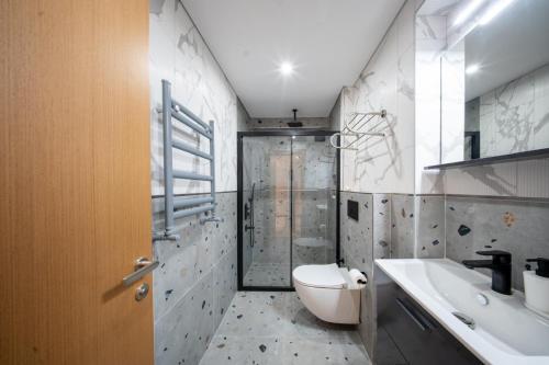 a bathroom with a shower and a toilet and a sink at Hay Rezidans in Istanbul
