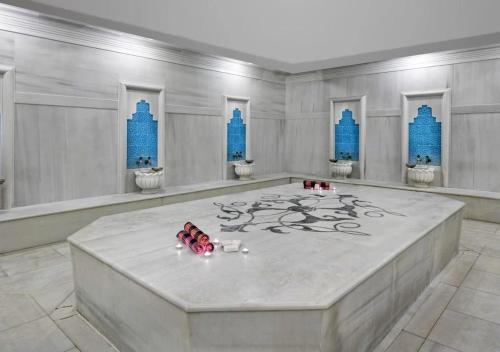 a room with a large white room with blue buildings at Özkaymak Select Resort Hotel - Ultra All Inclusive in Alanya