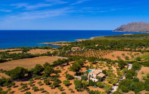an aerial view of a house on a hill next to the ocean at Villa Maria De Betlem in Colonia de Sant Pere