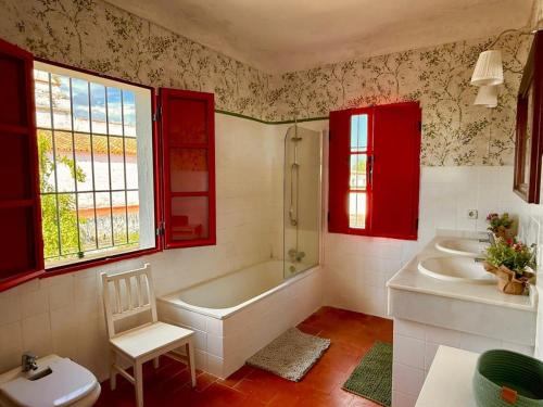 a bathroom with a tub and a sink and a toilet at Hacienda Don Rodrigo in Alcalá de Guadaira