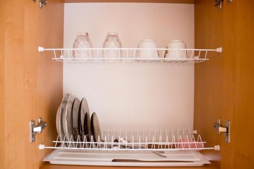 a kitchen with plates and bowls on a shelf at Hotel Uyut in Kremenchuk