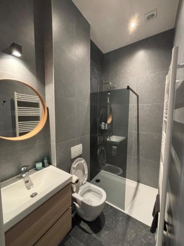 a bathroom with a toilet and a sink and a shower at Modern apartment - Lier in Lier