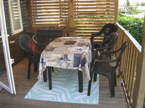 a table and four chairs on a porch at erick in Angles