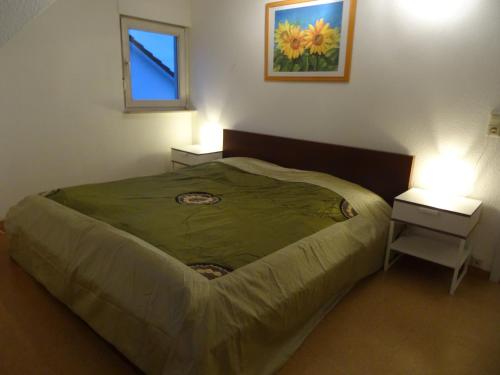 a bedroom with a large bed with two night stands at Ferienwohnung Strunz Backnang ruhig zentrumsnah & S-Bahn in Backnang