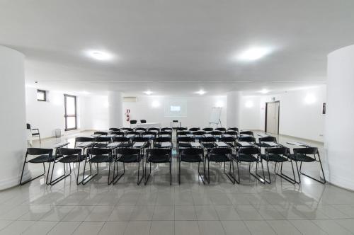 a room with a large room with chairs in it at Sotel Nomentana Roma in Rome