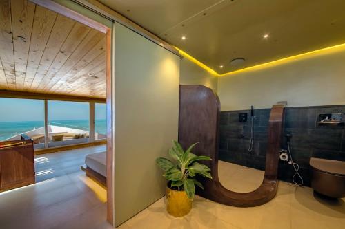 a bathroom with a tub and a sink and a toilet at Jungle Beach Ahungalla in Ahungalla