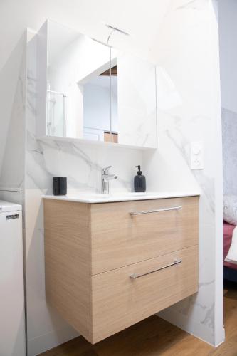 a bathroom with a sink and a mirror at L'auberge du Paon in Troyes
