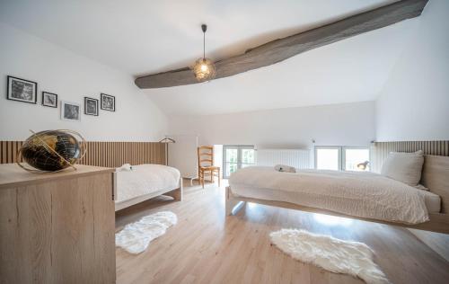a bedroom with two beds and a couch and a table at Les Trésors de Givry in Givry