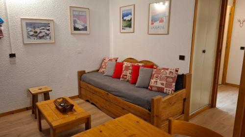 a bedroom with a wooden bed with pillows on it at Montchavin la Plagne N10 in La Plagne Tarentaise