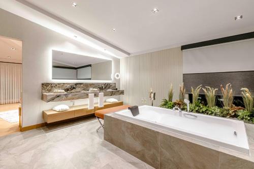 a bathroom with a large bath tub with plants at AHC Taksim Hotel-Special Class in Istanbul