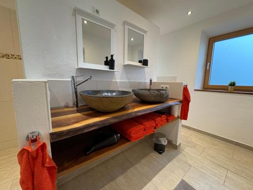 a bathroom with a bowl sink on a counter at FeWo Landidyll in Dürrnberg