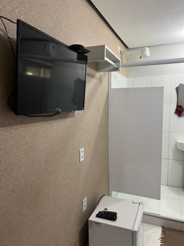 a flat screen tv hanging on a wall in a bathroom at Hotel Santa Rita in Amarante do Maranhão