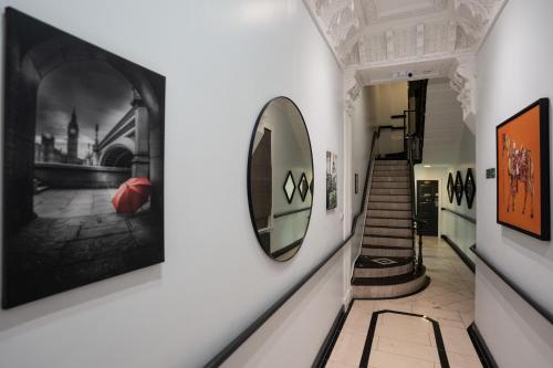 a hallway with art on the walls and a mirror at MSK Premium in London